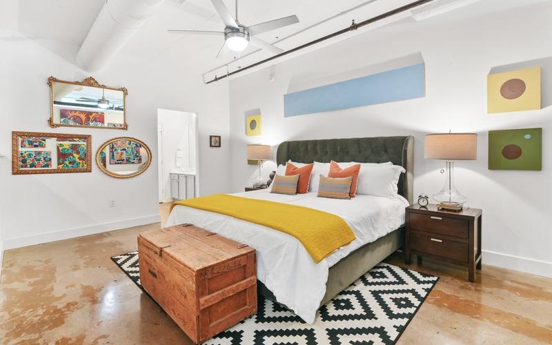 a bedroom with a bed and lamps