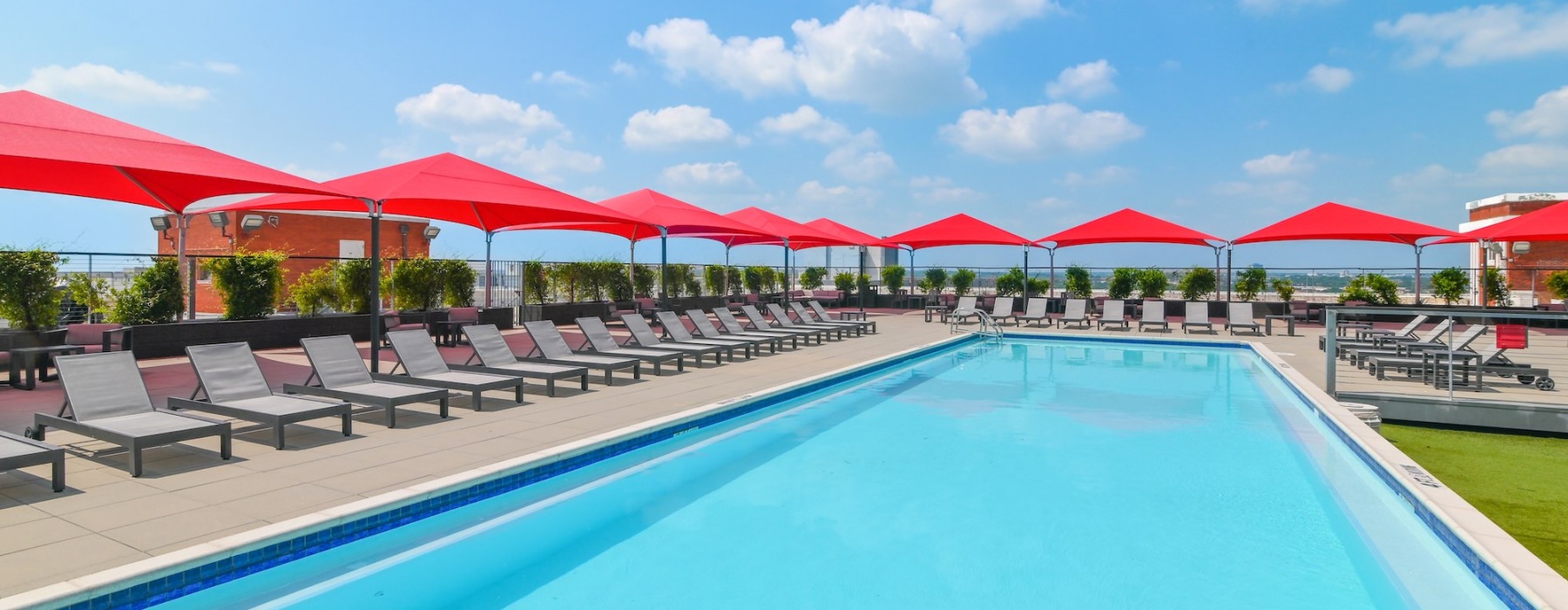 resort style pool with seating and umbrellas